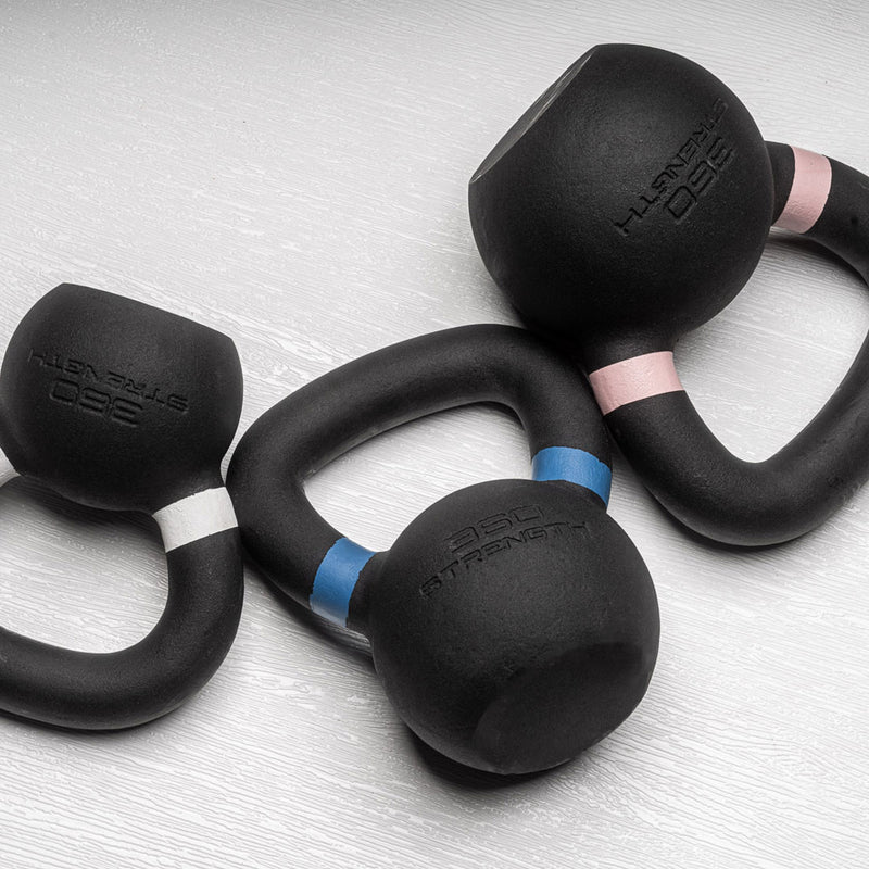 Three kettlebells on papers